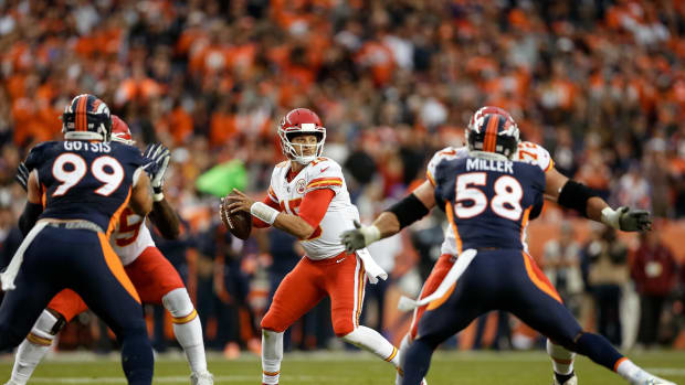 Oct 1, 2018; Denver, CO, USA; Kansas City Chiefs quarterback Patrick Mahomes (15) drops back to pass as offensive lineman Cameron Erving (75) and offensive tackle Eric Fisher (72) block against Denver Broncos defensive end Adam Gotsis (99) and linebacker Von Miller (58) in the first quarter at Broncos Stadium at Mile High.